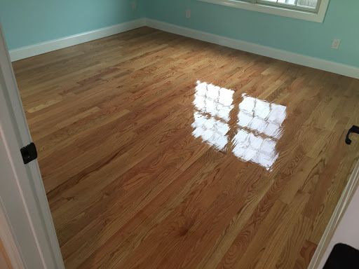 A bedroom with hardwood floors and blue walls.