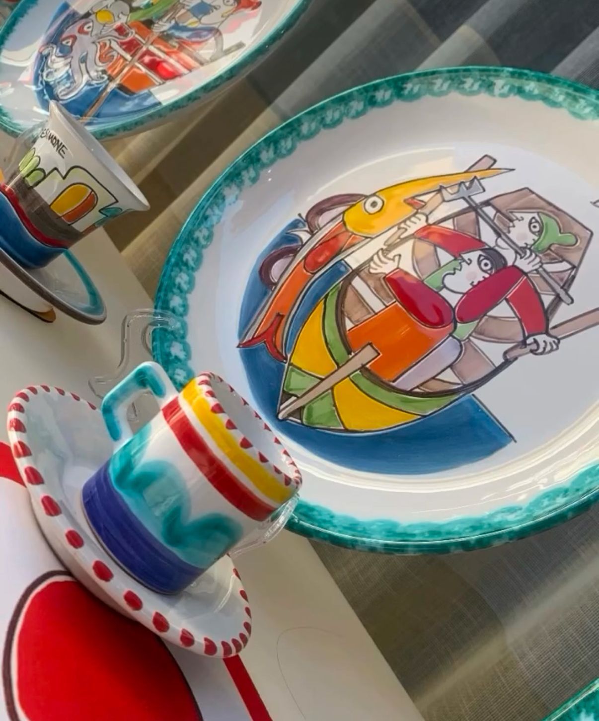 Un piatto con una barca sopra e una tazza su un piattino