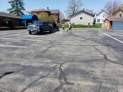 A truck is parked in the middle of a parking lot.