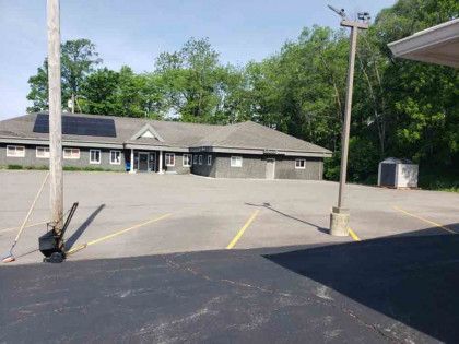 An empty parking lot with a building in the background