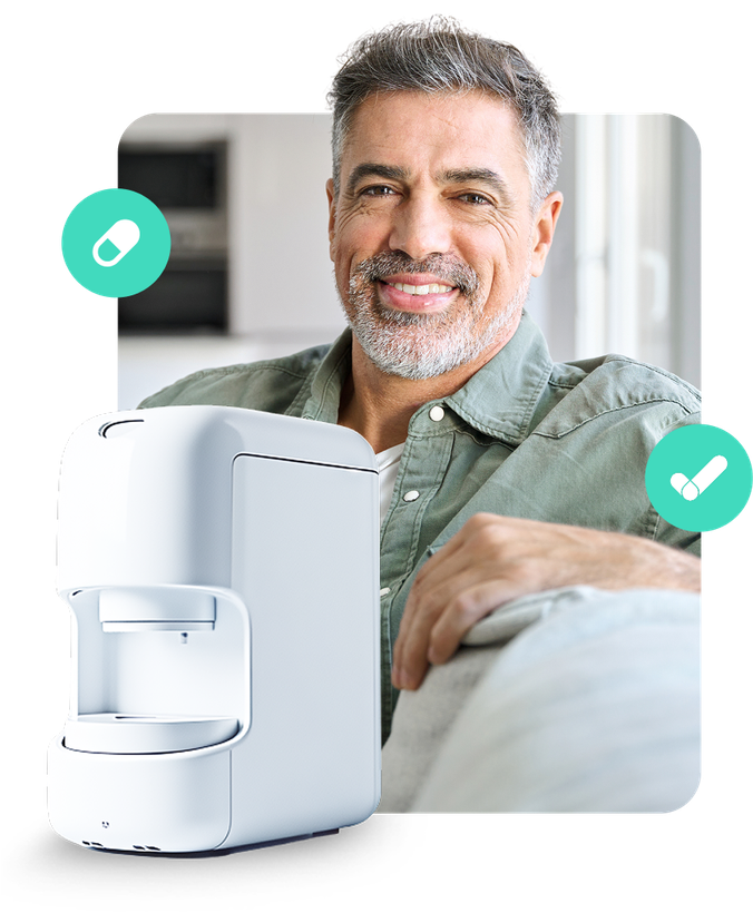 A man is sitting on a couch next to a coffee maker.