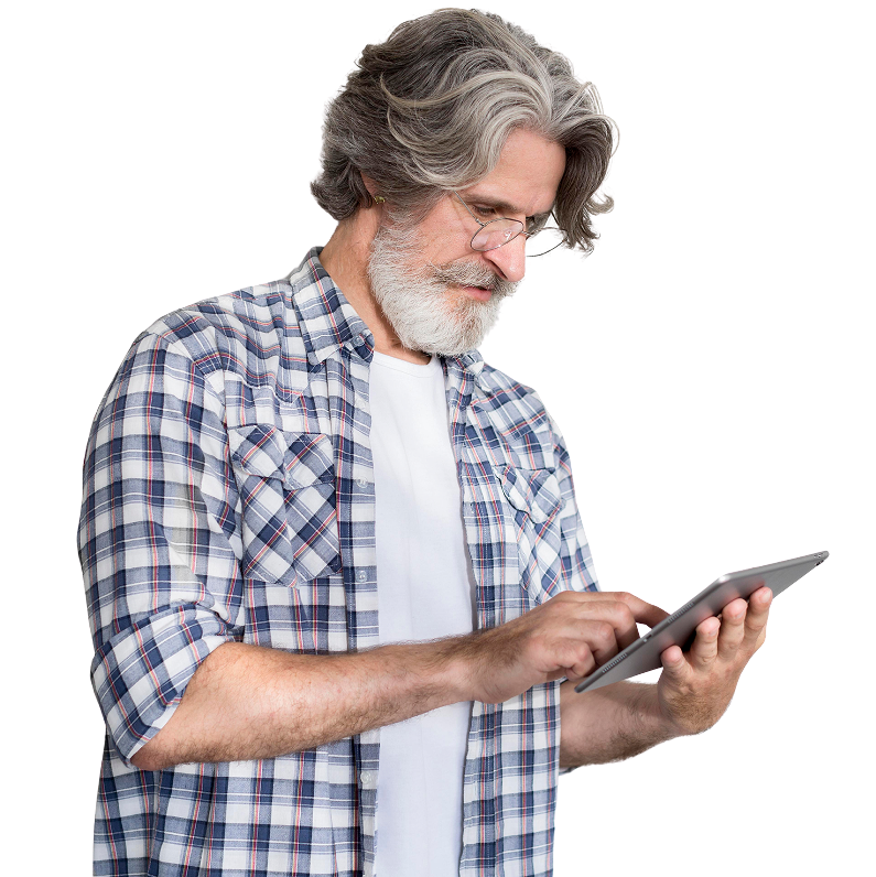 Man with gray hair and beard using a tablet, wearing glasses, and a plaid shirt.