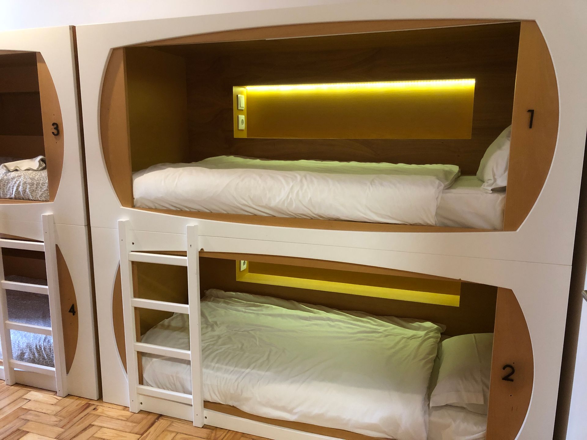 Three bunk beds are stacked on top of each other in a room.