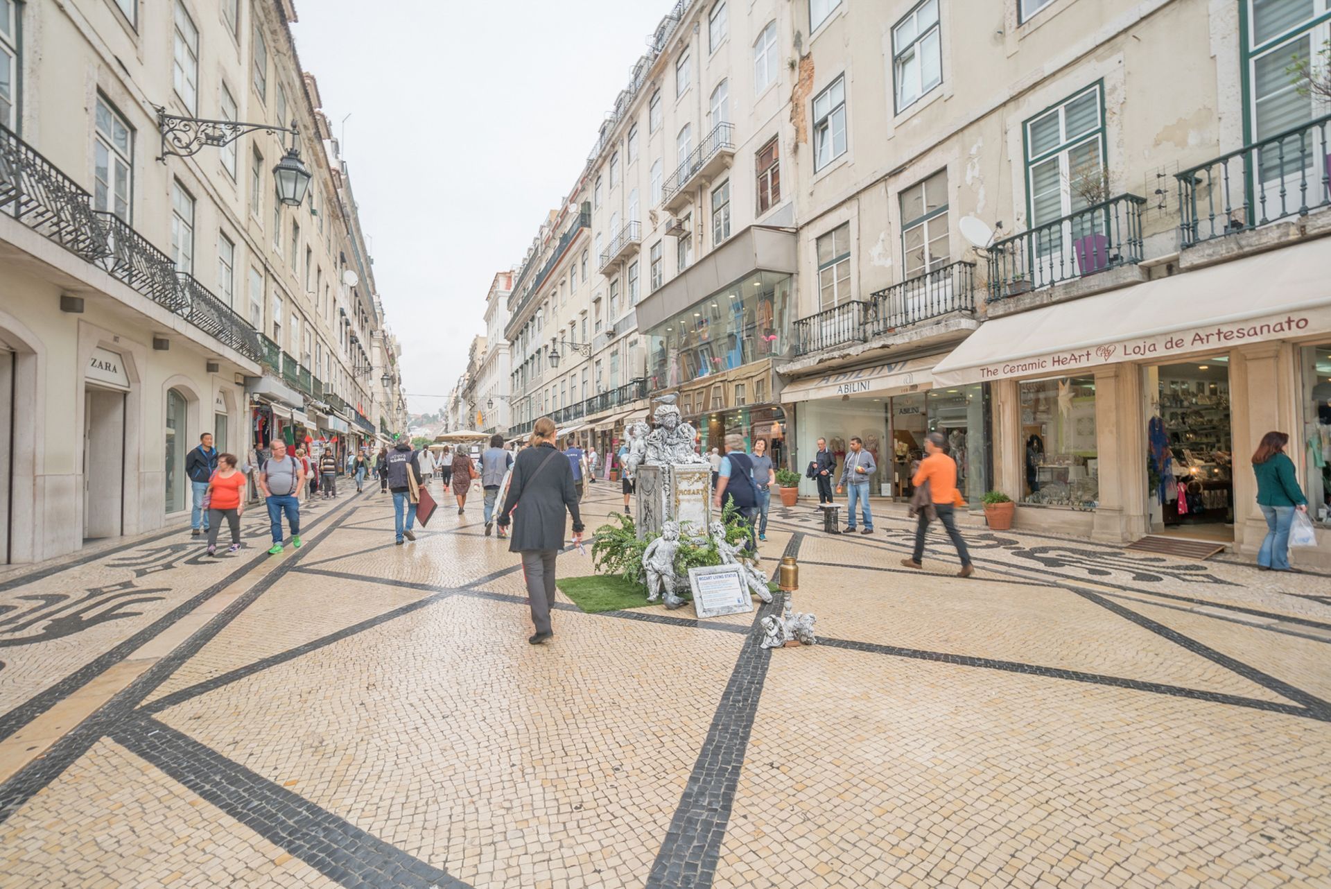 A group of people are walking down a busy city street.