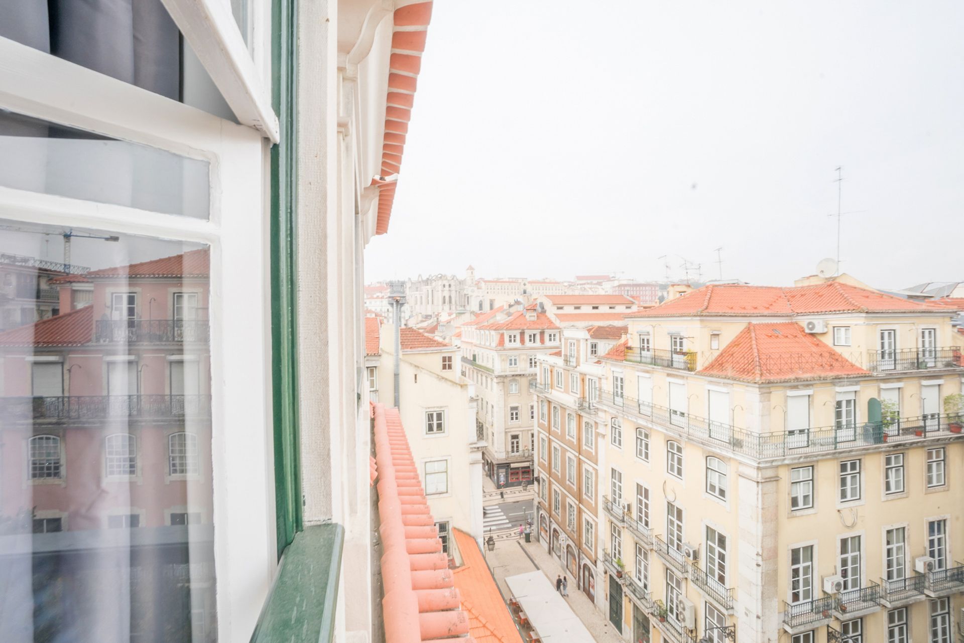 A view of a city from a balcony of a building.