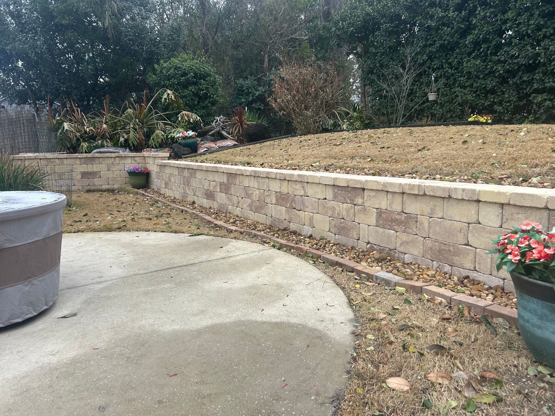 A construction worker is laying bricks on a construction site with a shovel.