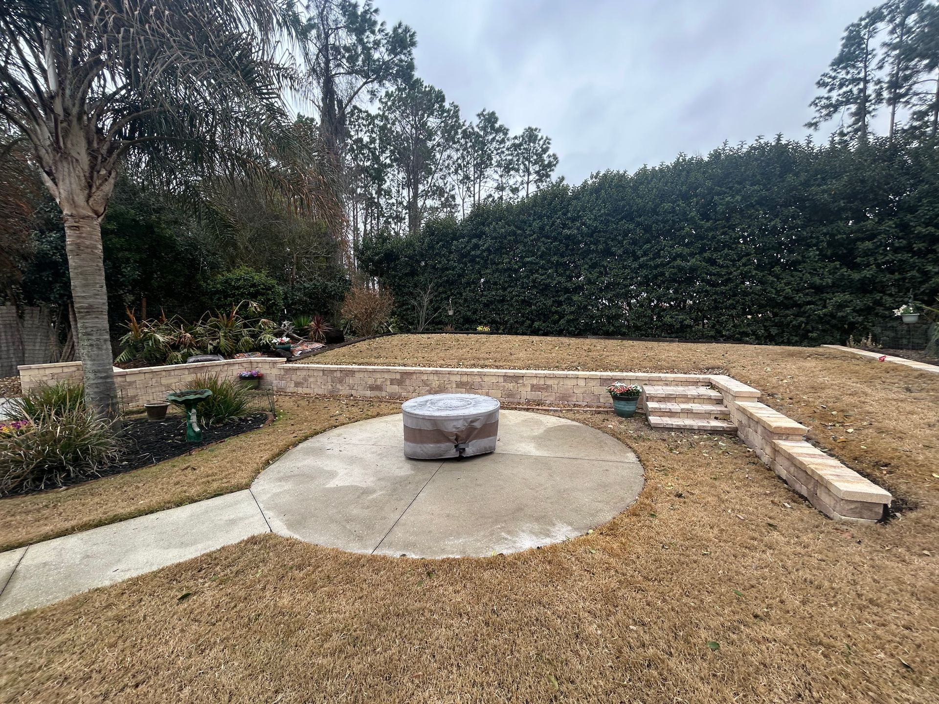A construction worker is laying bricks on a construction site with a shovel.