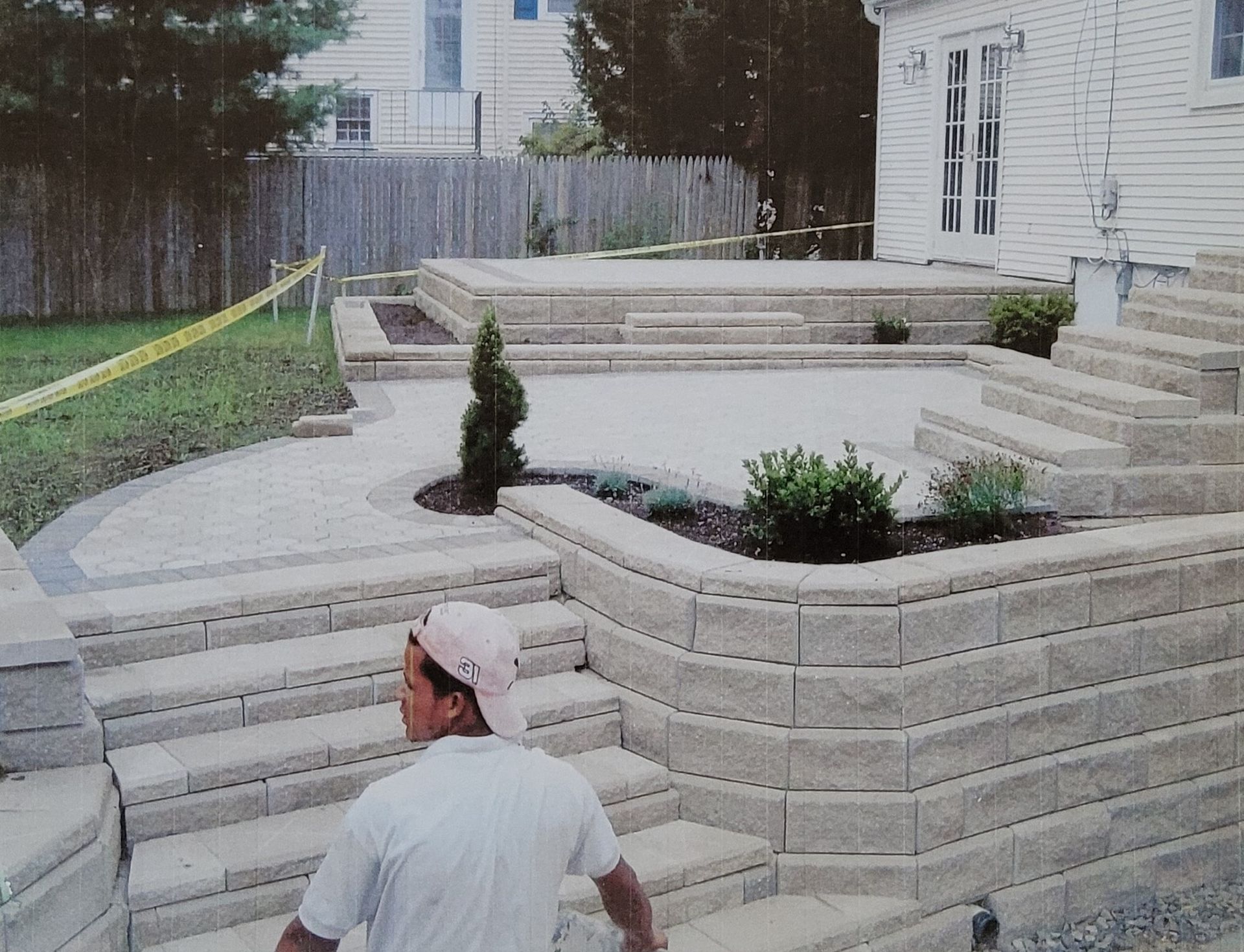 A man is standing on a set of stairs in front of a house