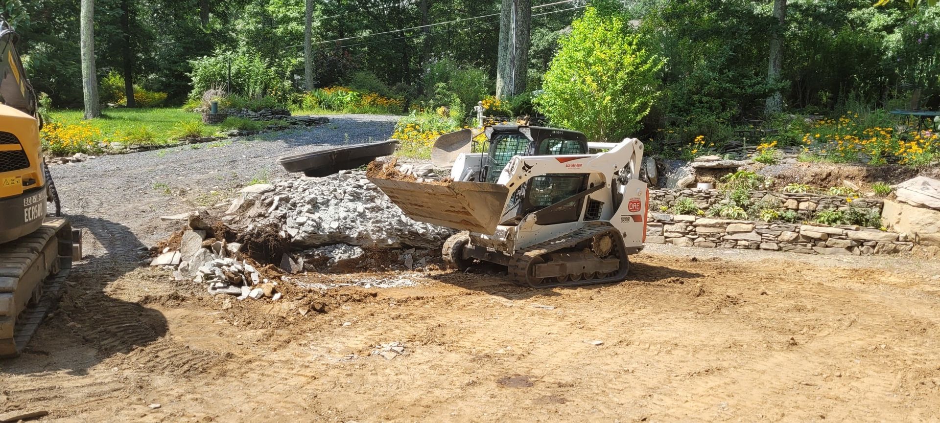 A woman is holding two potted plants in a greenhouse.