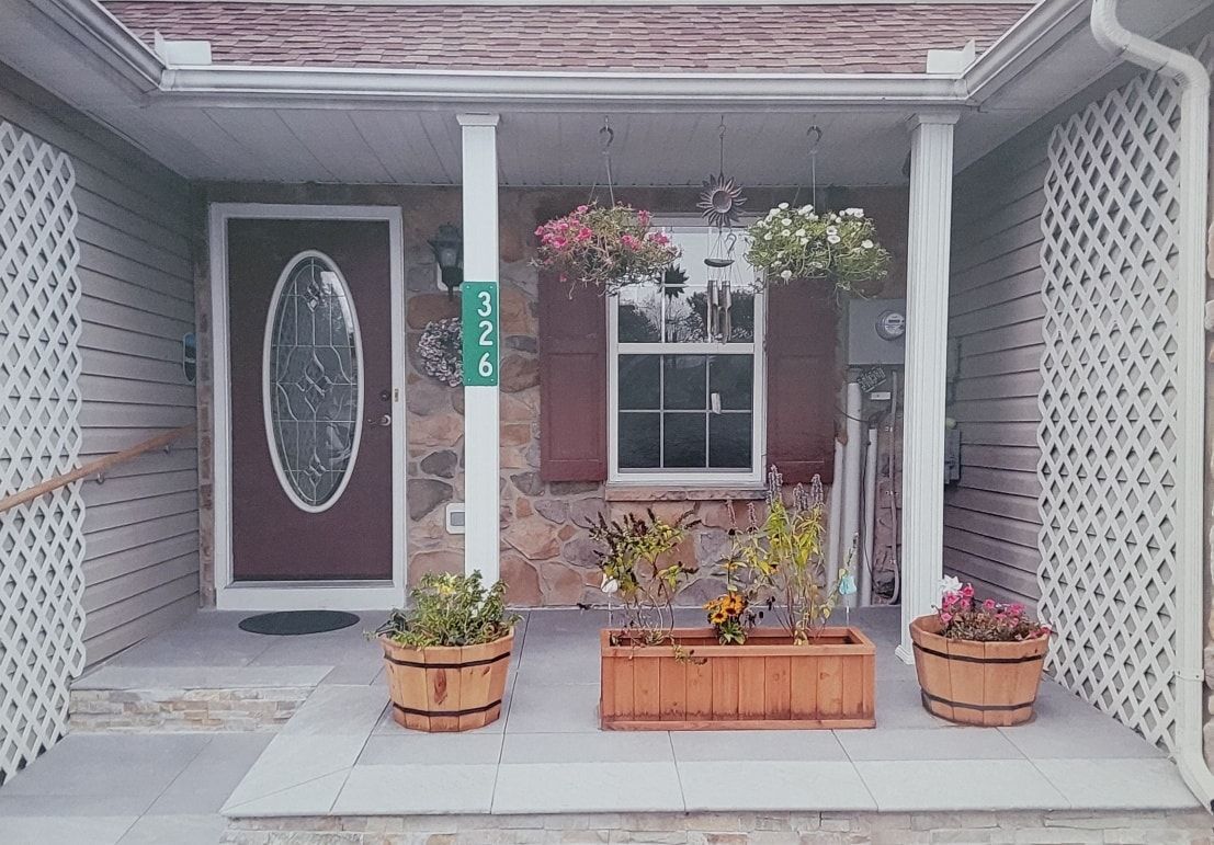 The front porch of a house with a sign that says ' e-mail ' on it