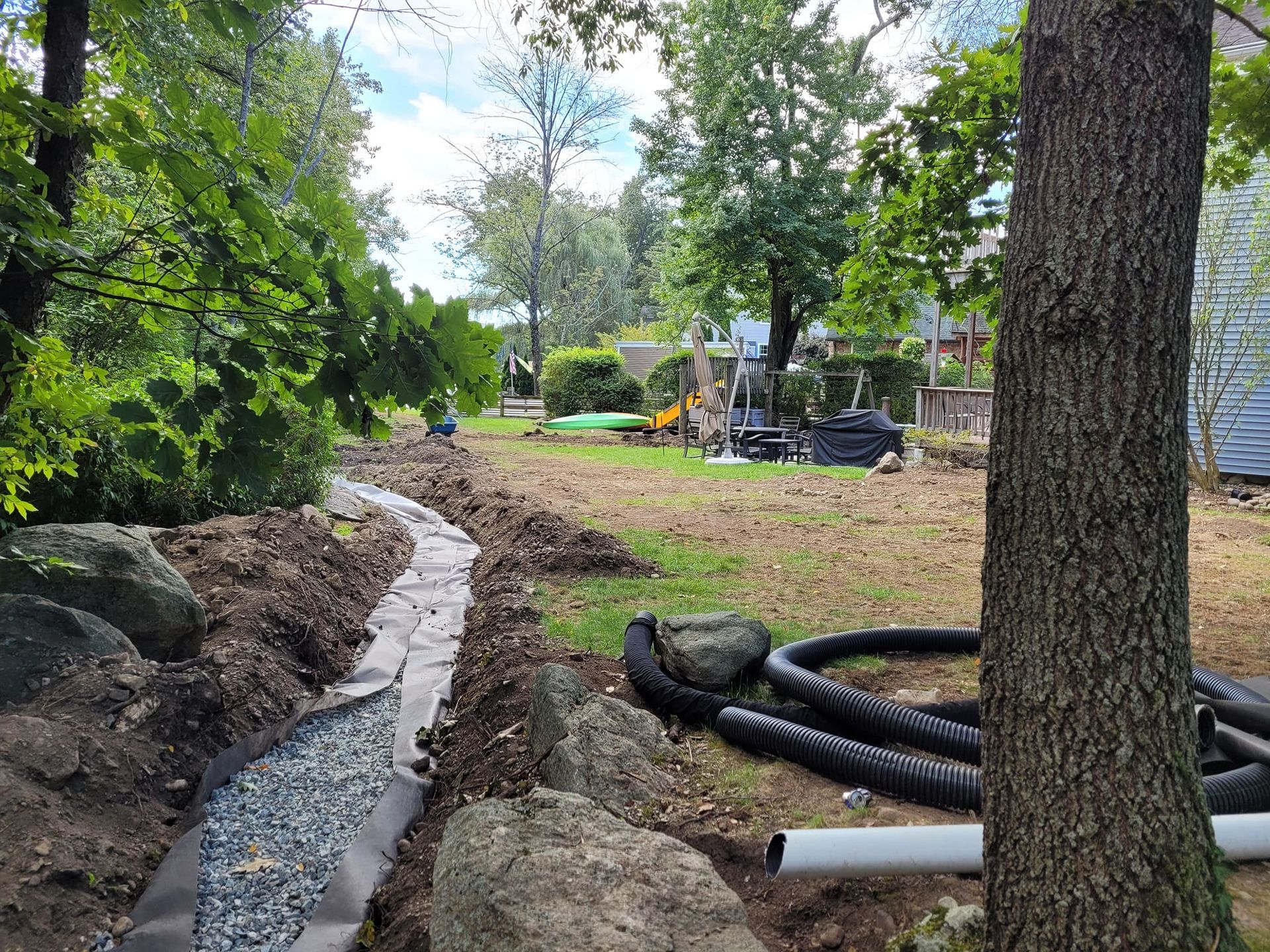 A lawn mower is cutting a lush green lawn.