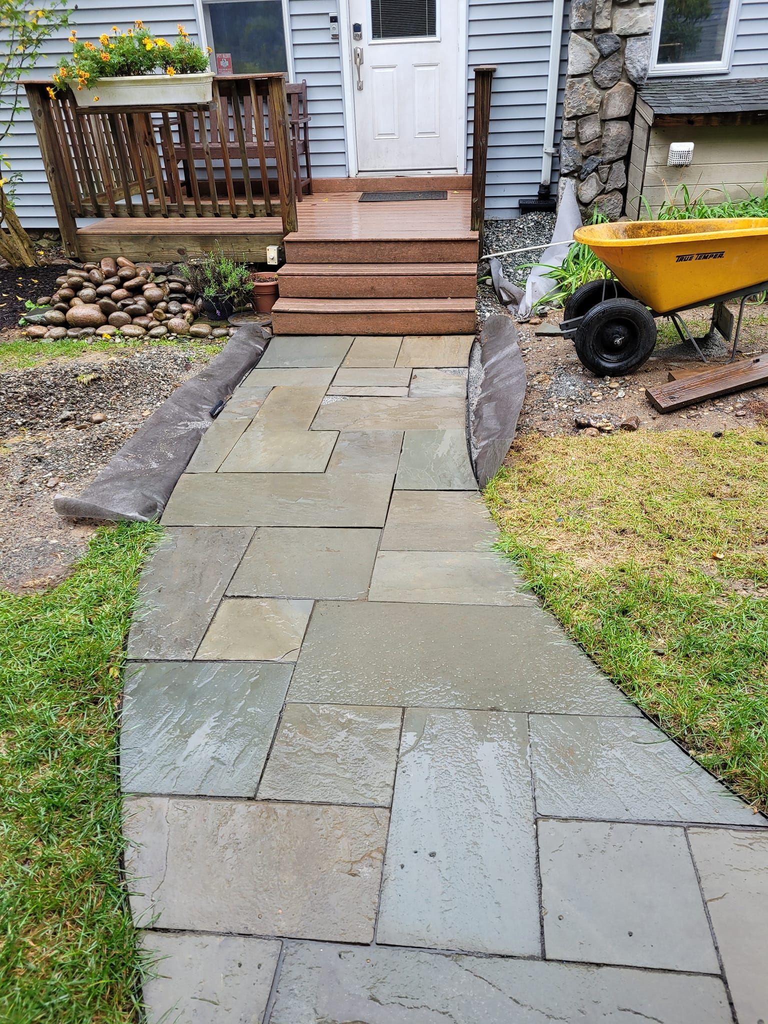 A stone walkway leading to the front door of a house.