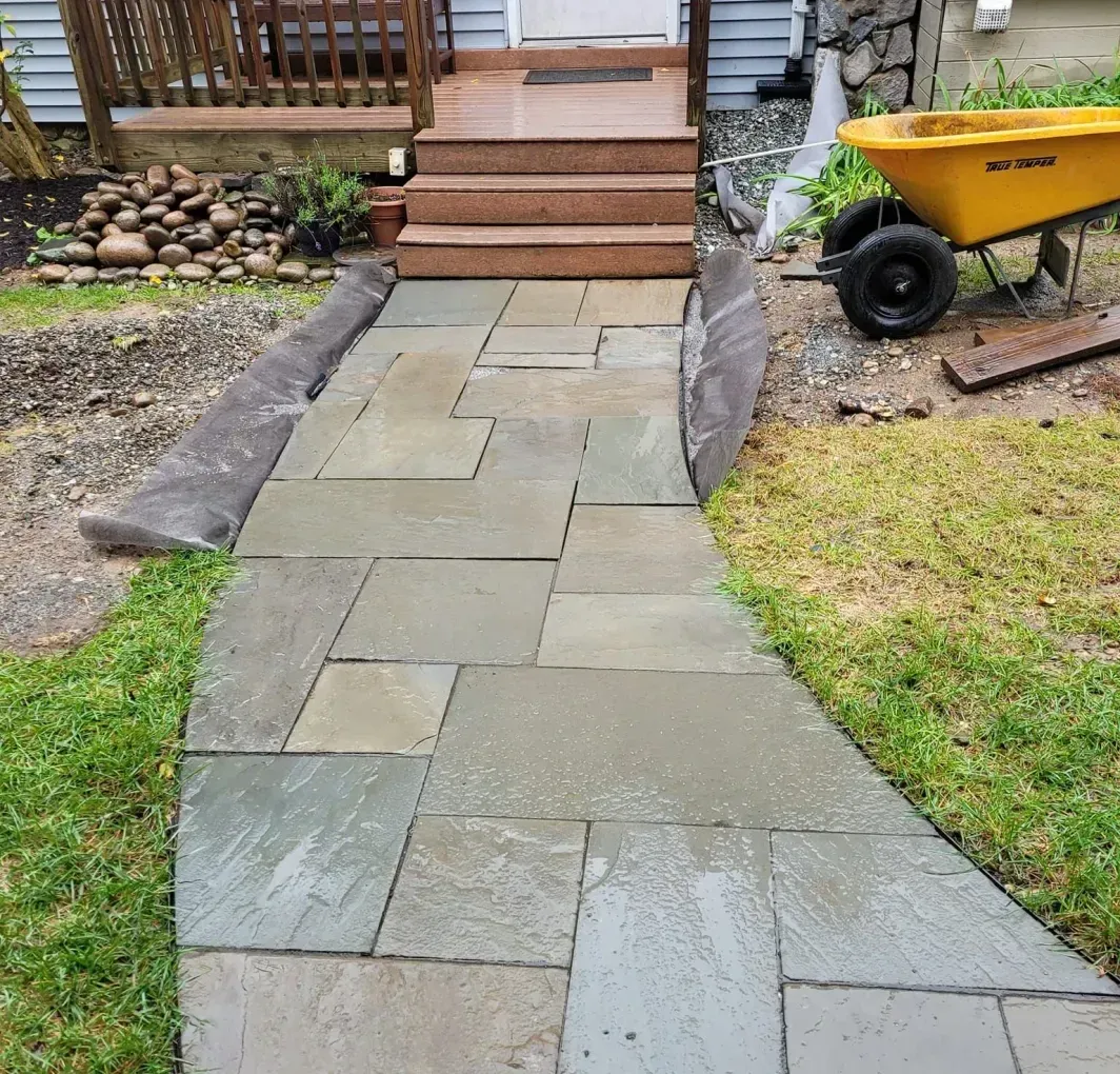 A stone walkway leading to the front door of a house.