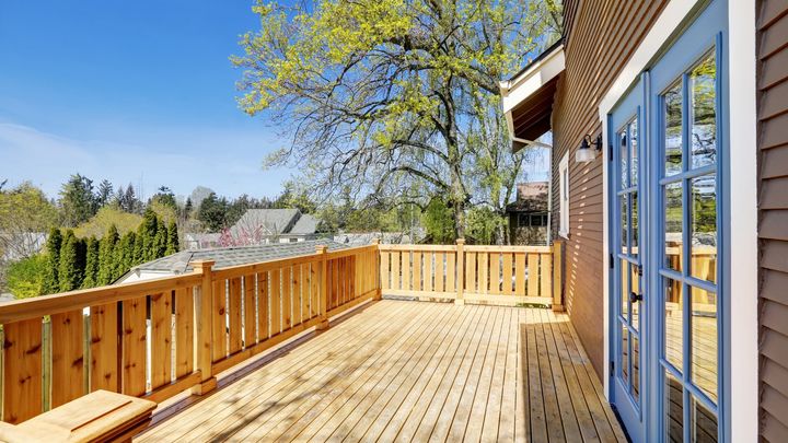 Wooden deck on the upper level of a house.
