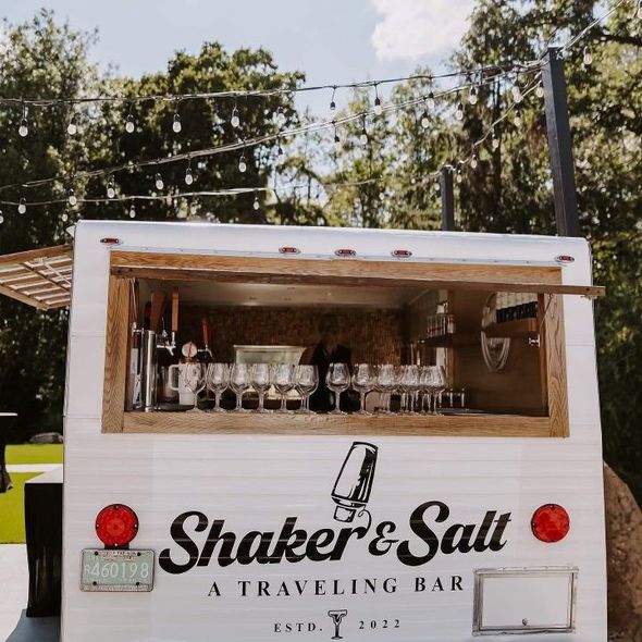 A white truck that says ' shaker & salt a traveling bar ' on it