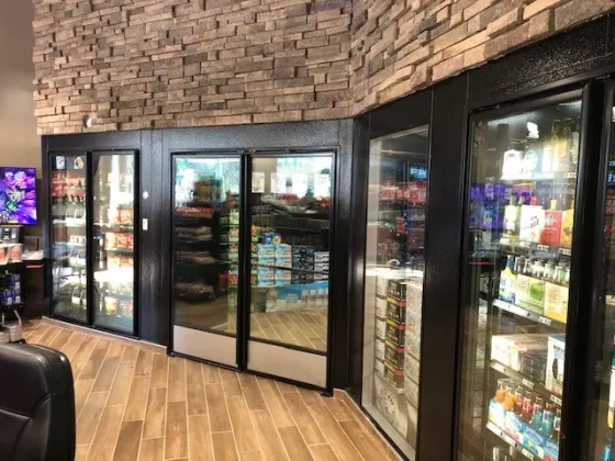 c-store-beverage-coolers-with-stone-rock-wall-above