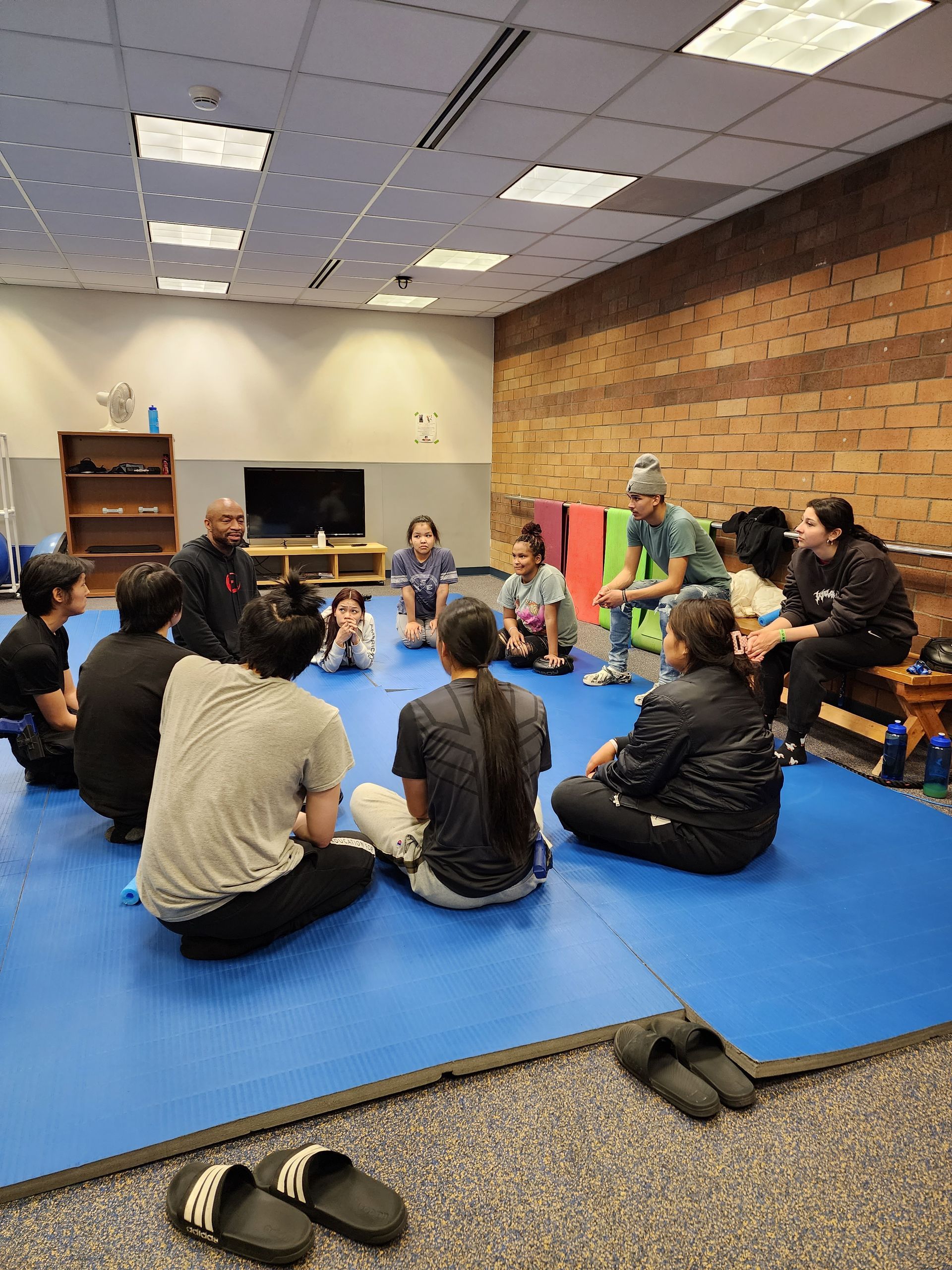 high school students listening to krav maga instructor