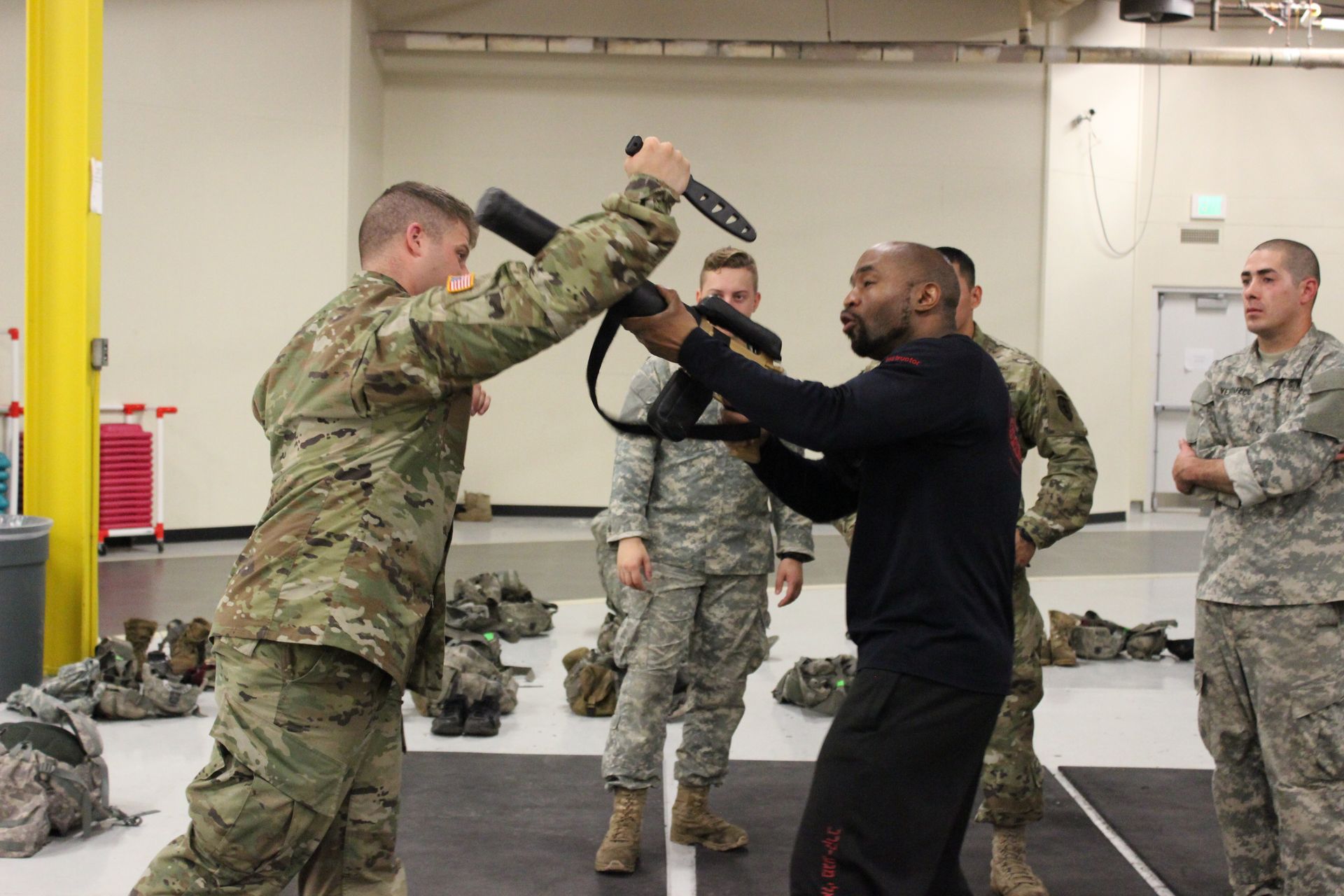 Military men training with rifle  and knife