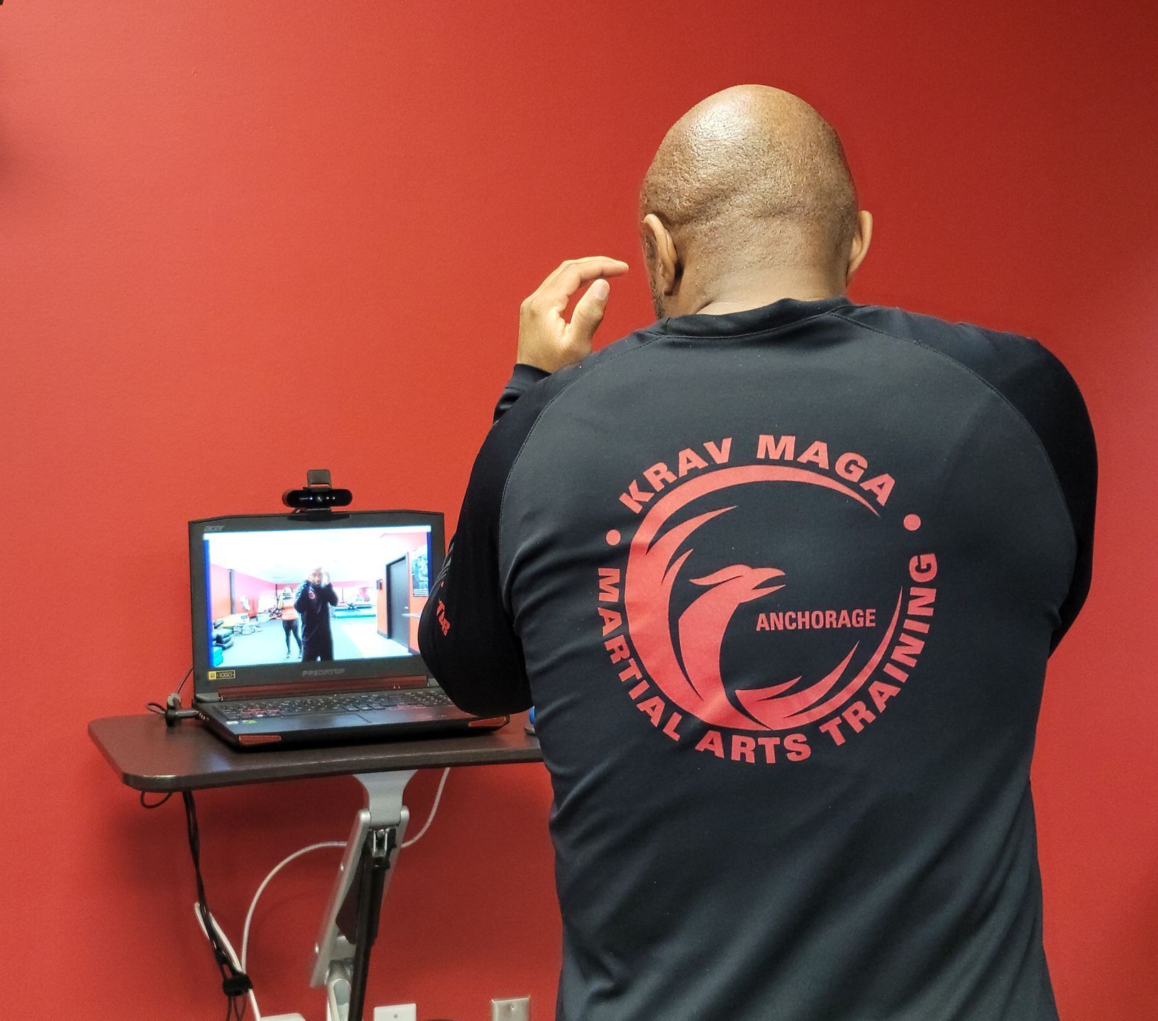 A man standing in front of the computer