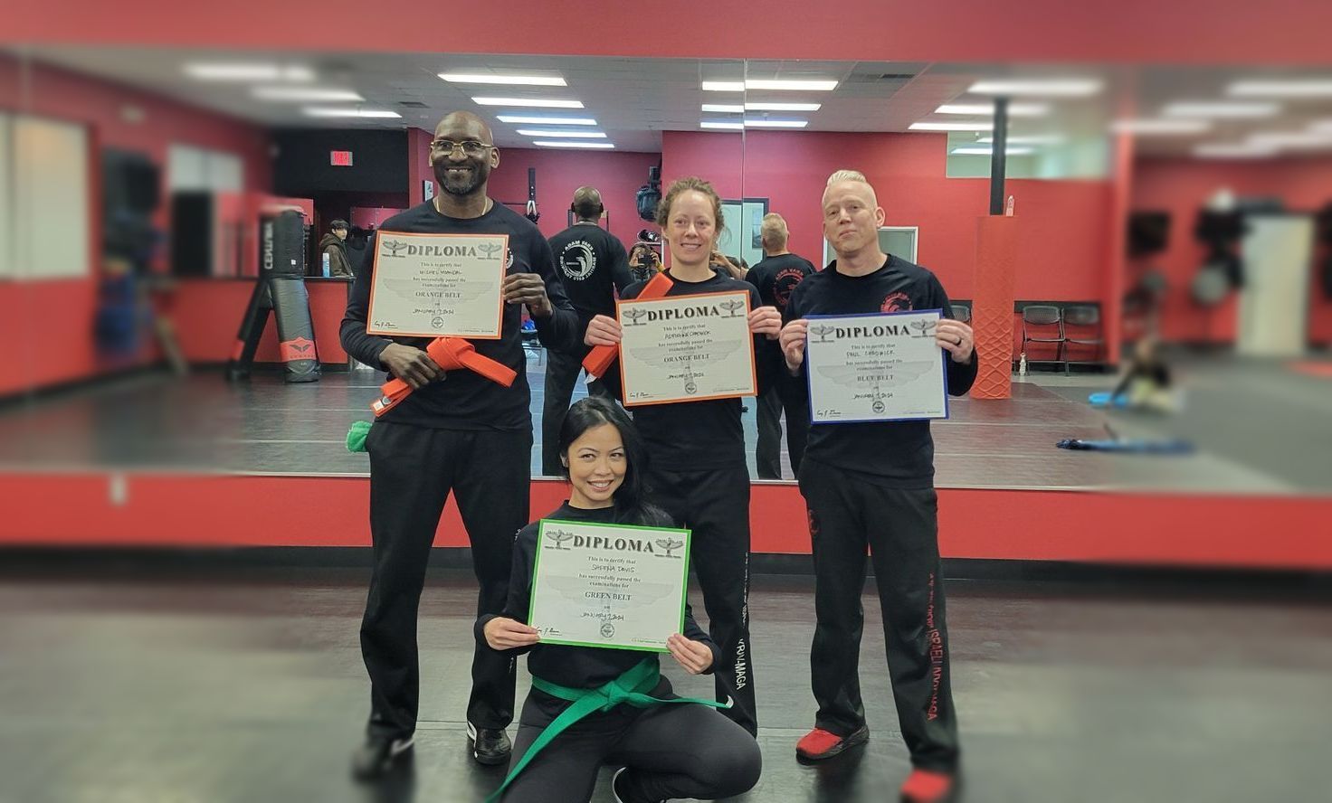men and women passing their belts in krav maga