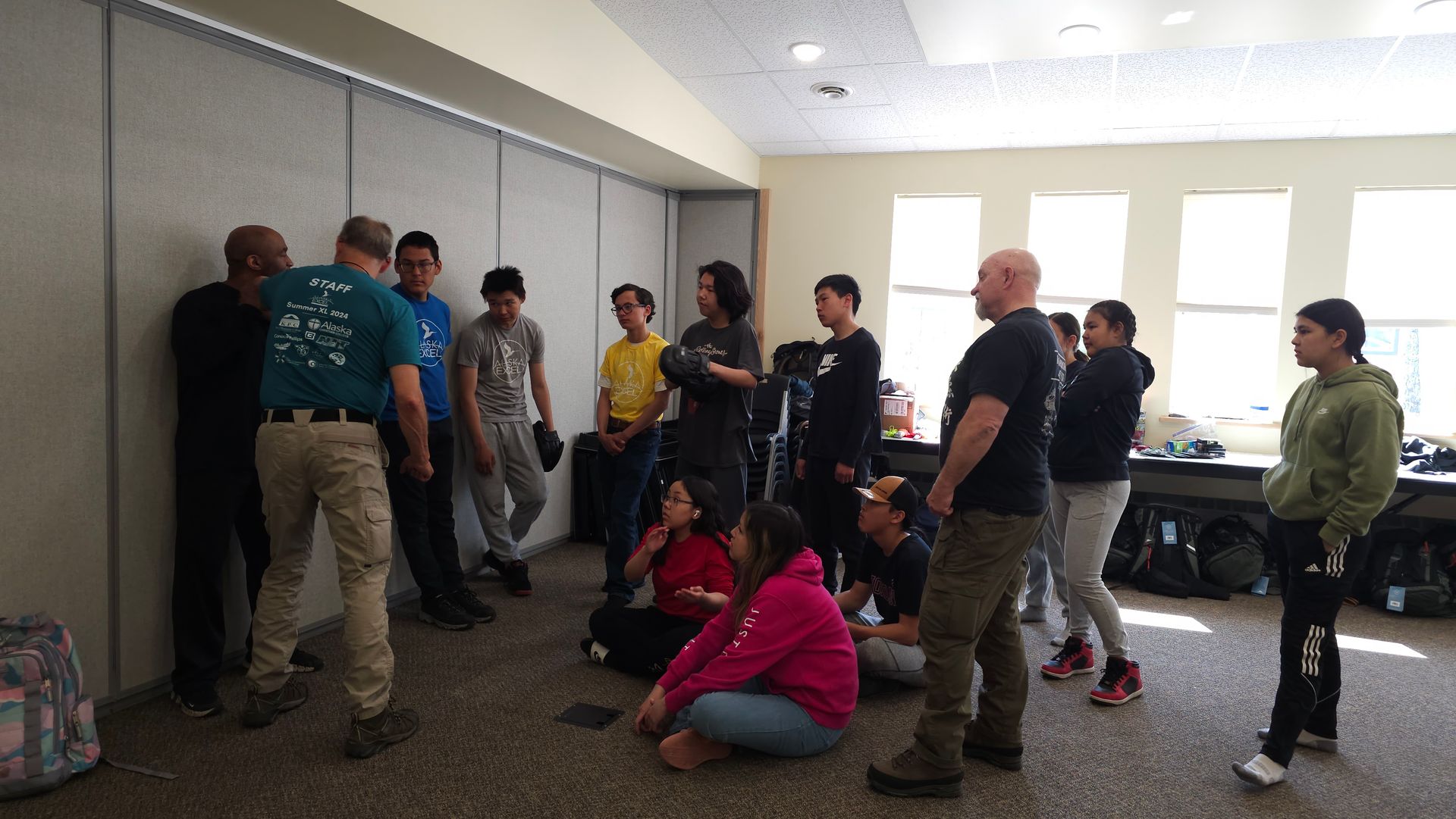 high school students listening to krav maga instructor