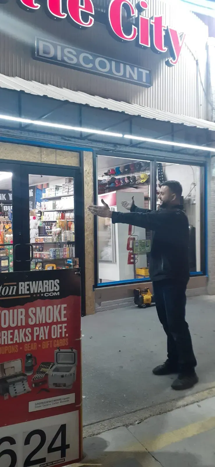Man gestures towards a storefront labeled 
