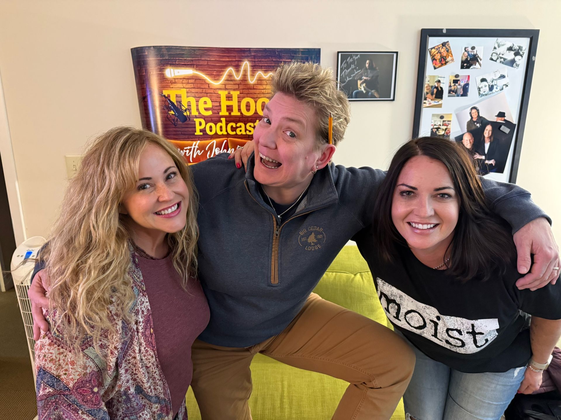 Three people posing together in front of a 