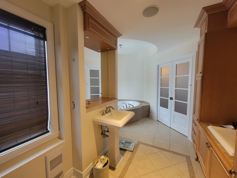 Une salle de bain avec un lavabo et une baignoire jacuzzi