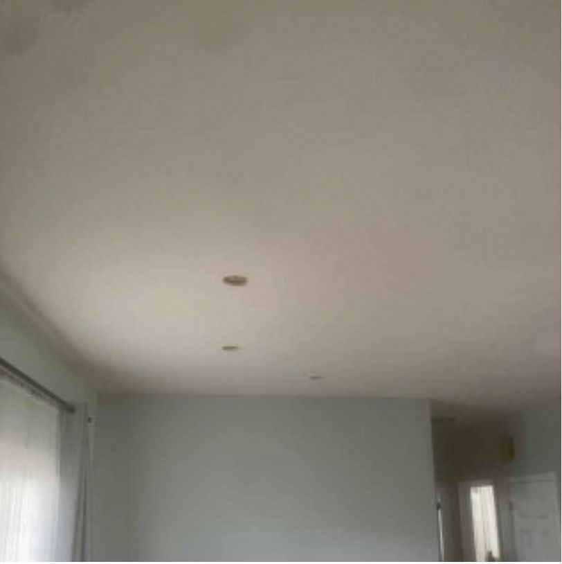 A living room with white walls and a white ceiling.