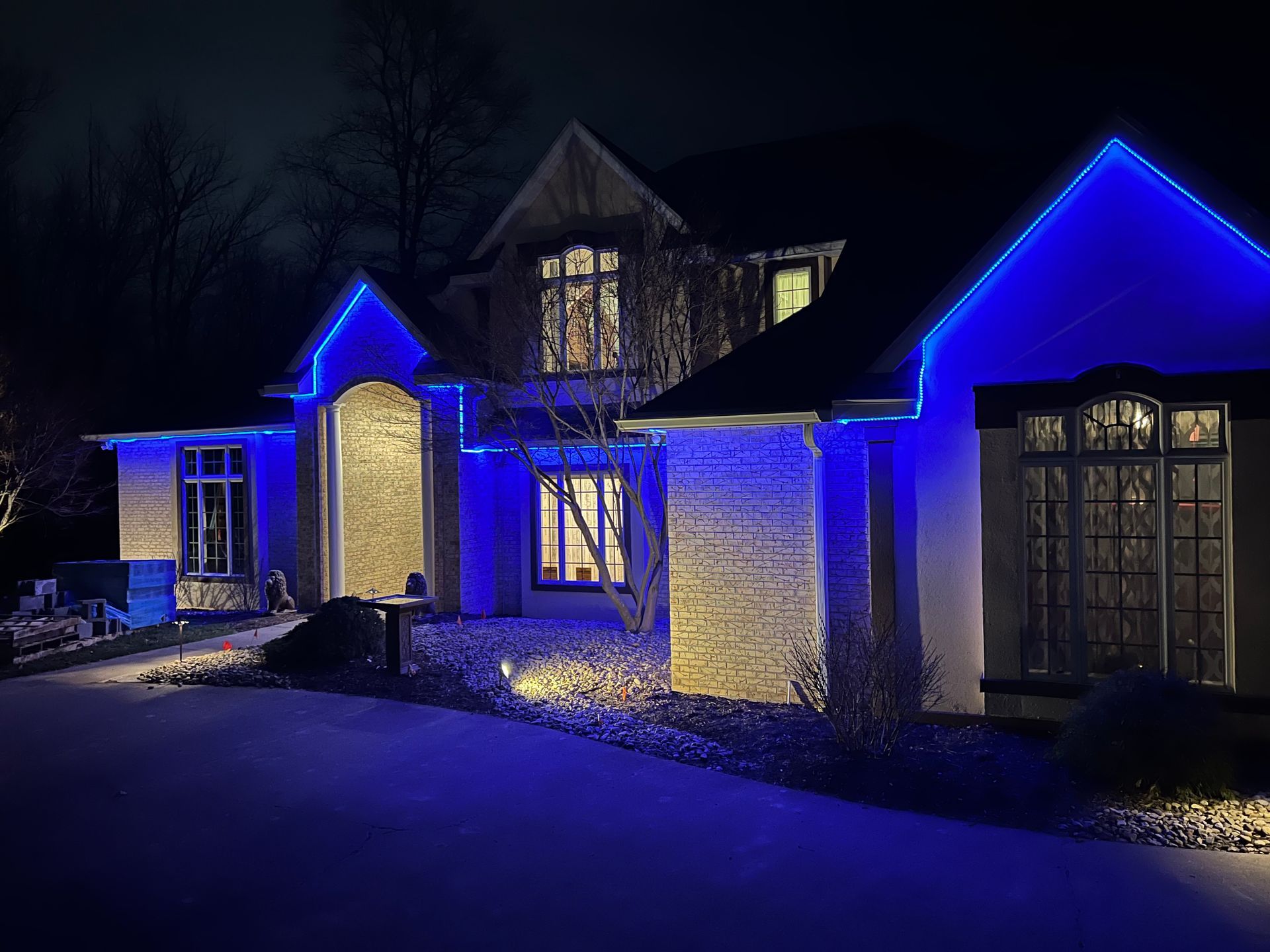 A house is lit up with blue lights at night.
