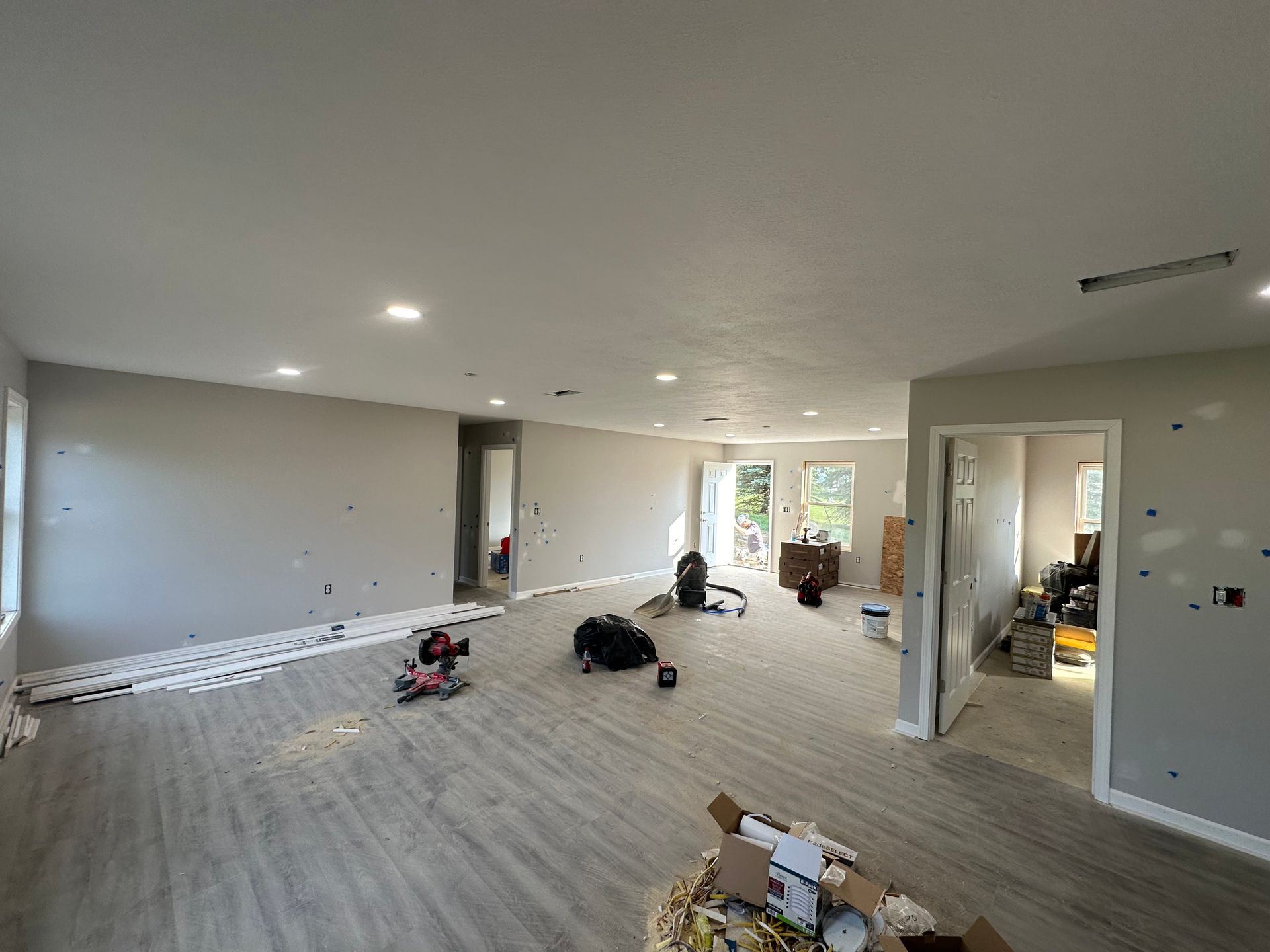 A large empty room with a lot of boxes on the floor.