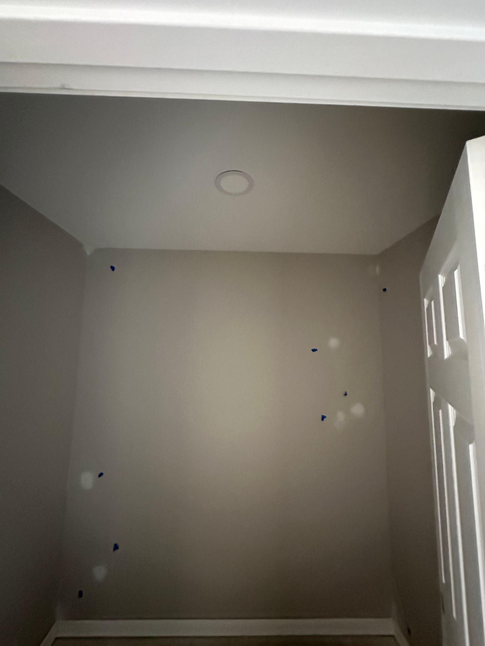 An empty room with a door and a light on the ceiling.