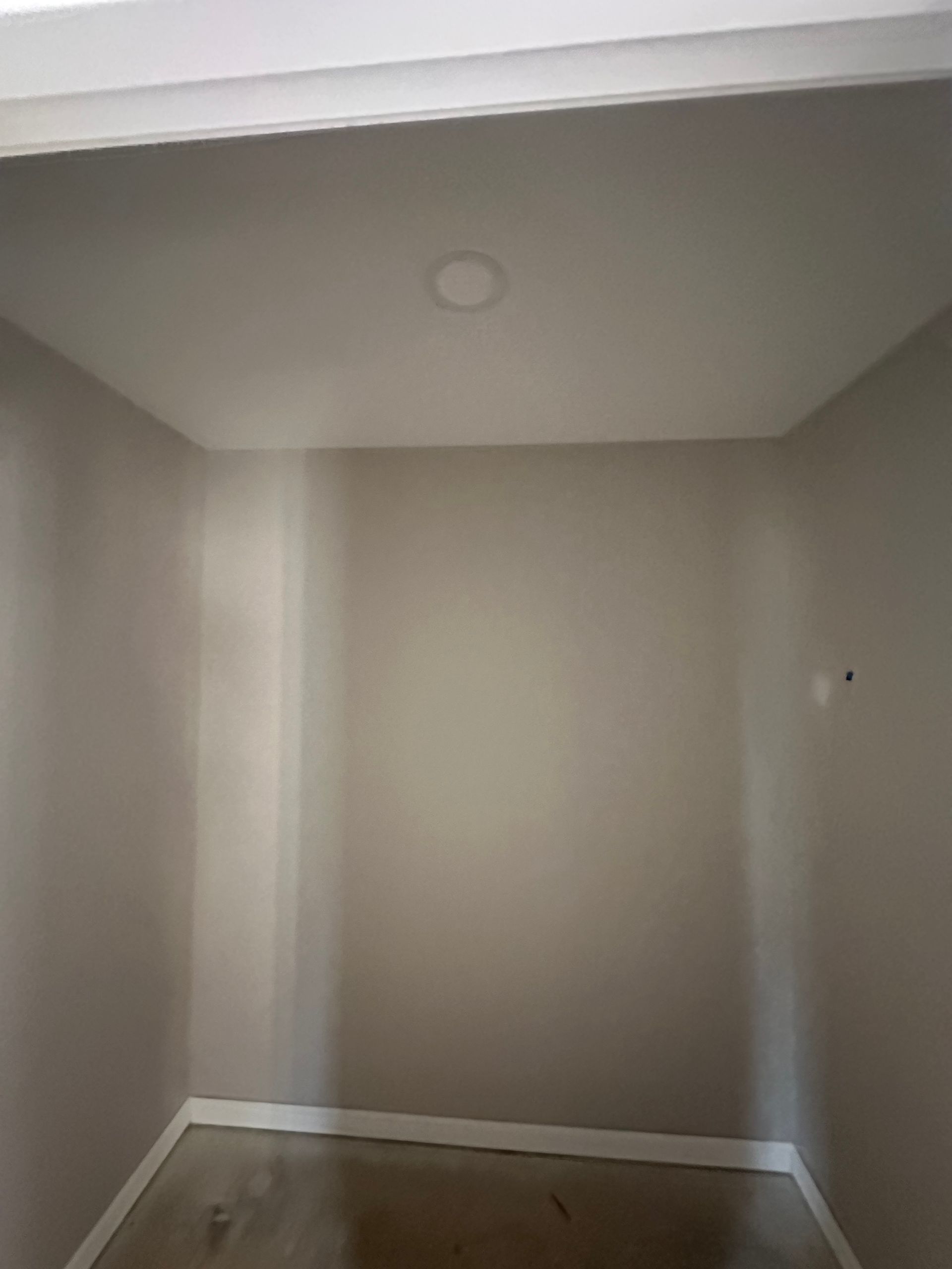 An empty room with a light on the ceiling.