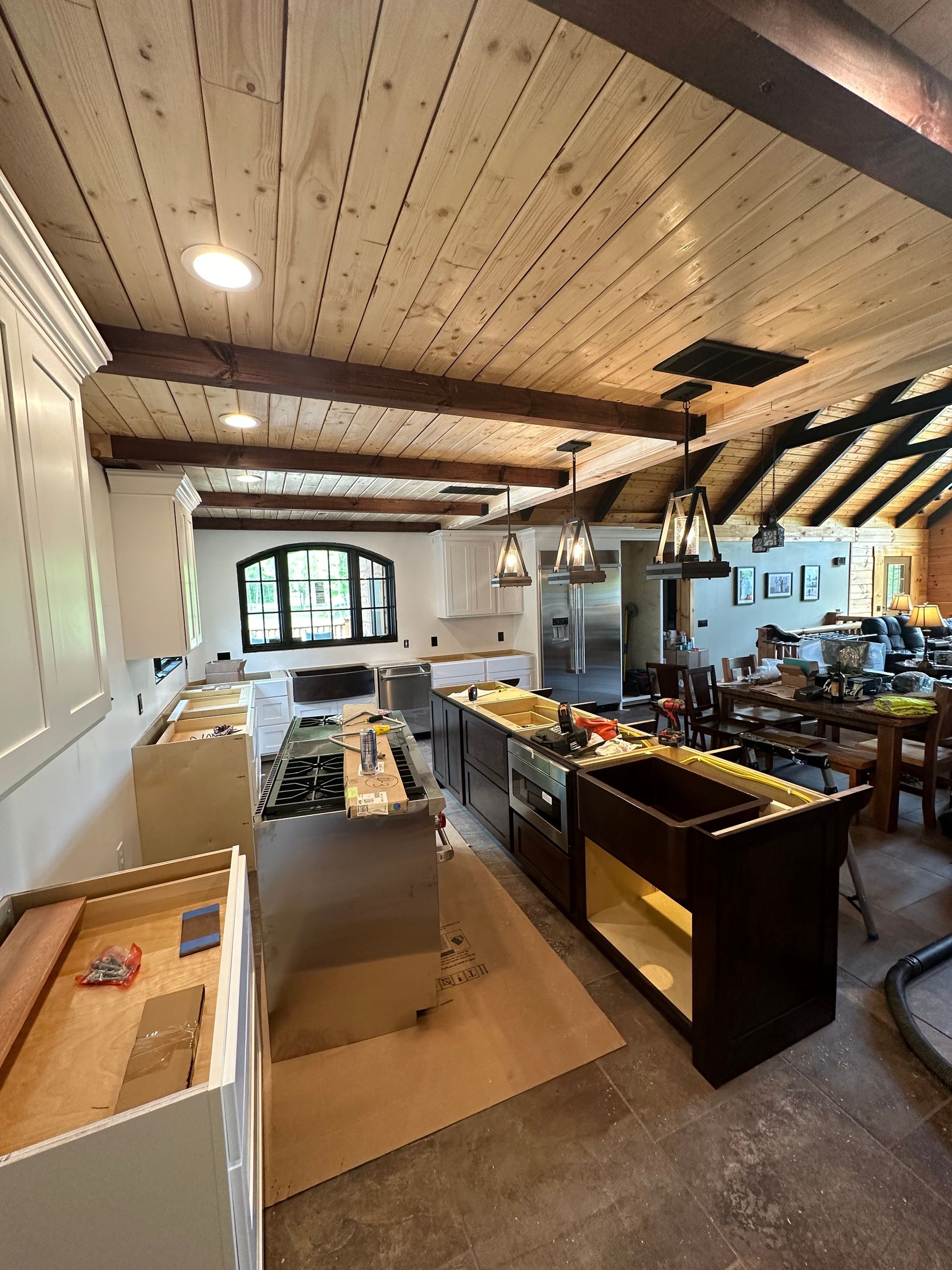 A kitchen with a wooden ceiling and a lot of cabinets