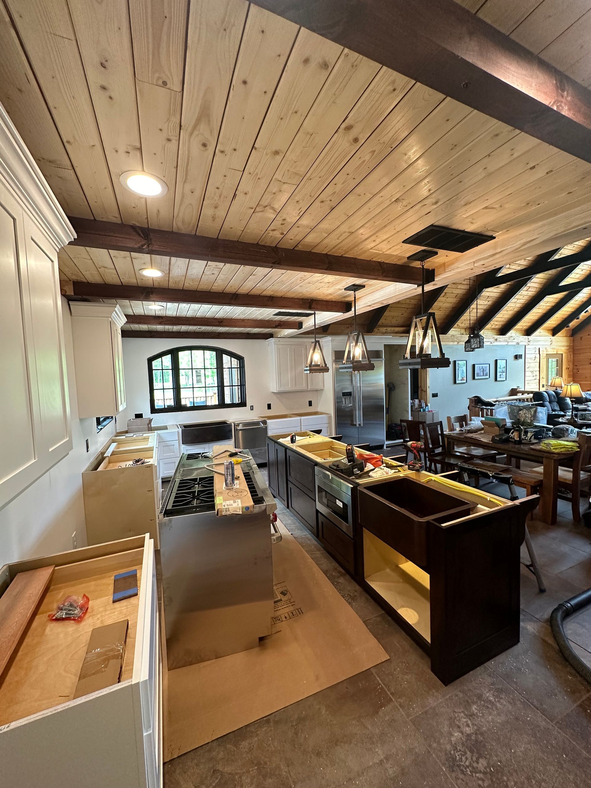 A kitchen with a wooden ceiling and stainless steel appliances