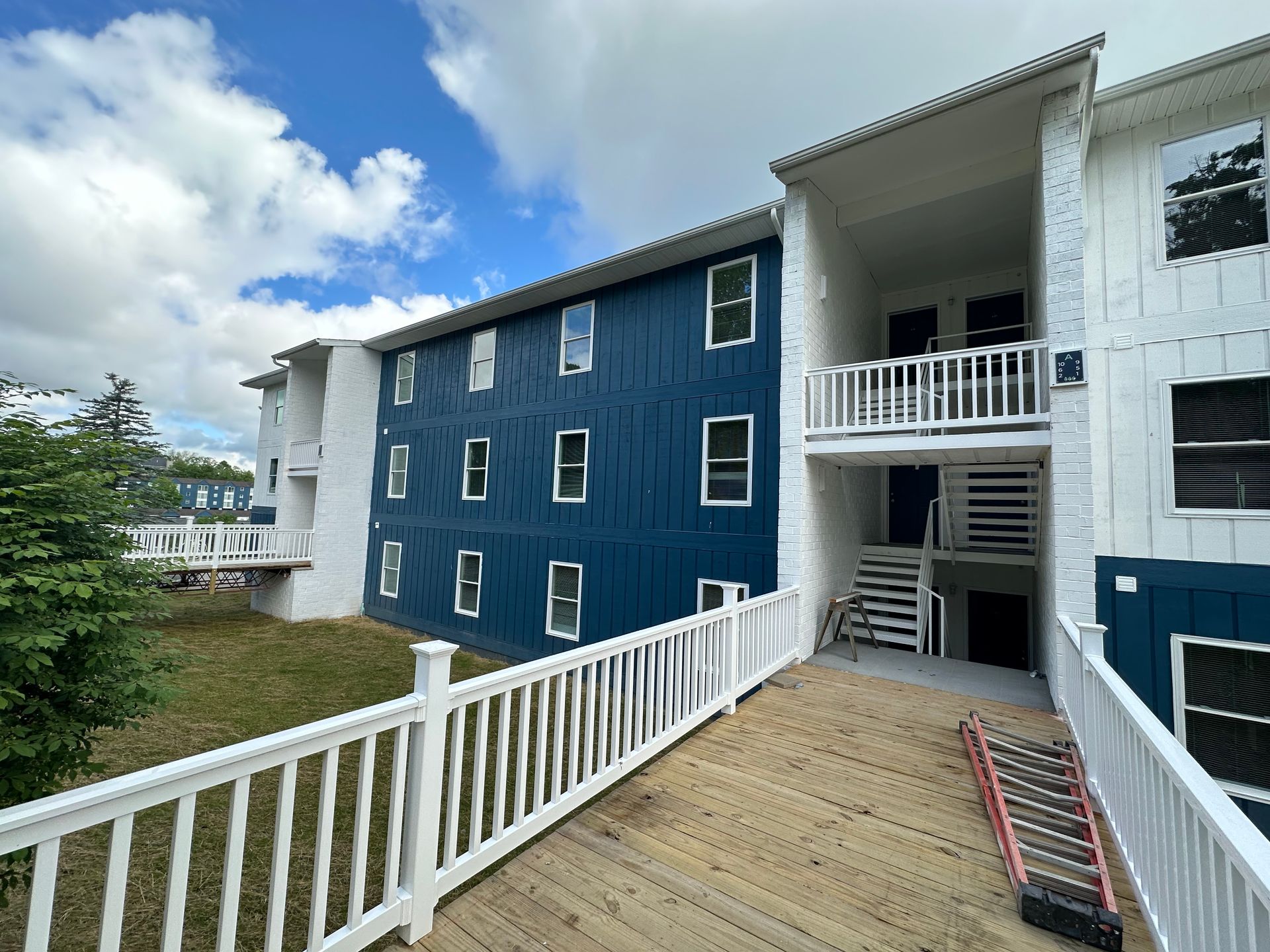 A blue and white building with stairs leading up to it.