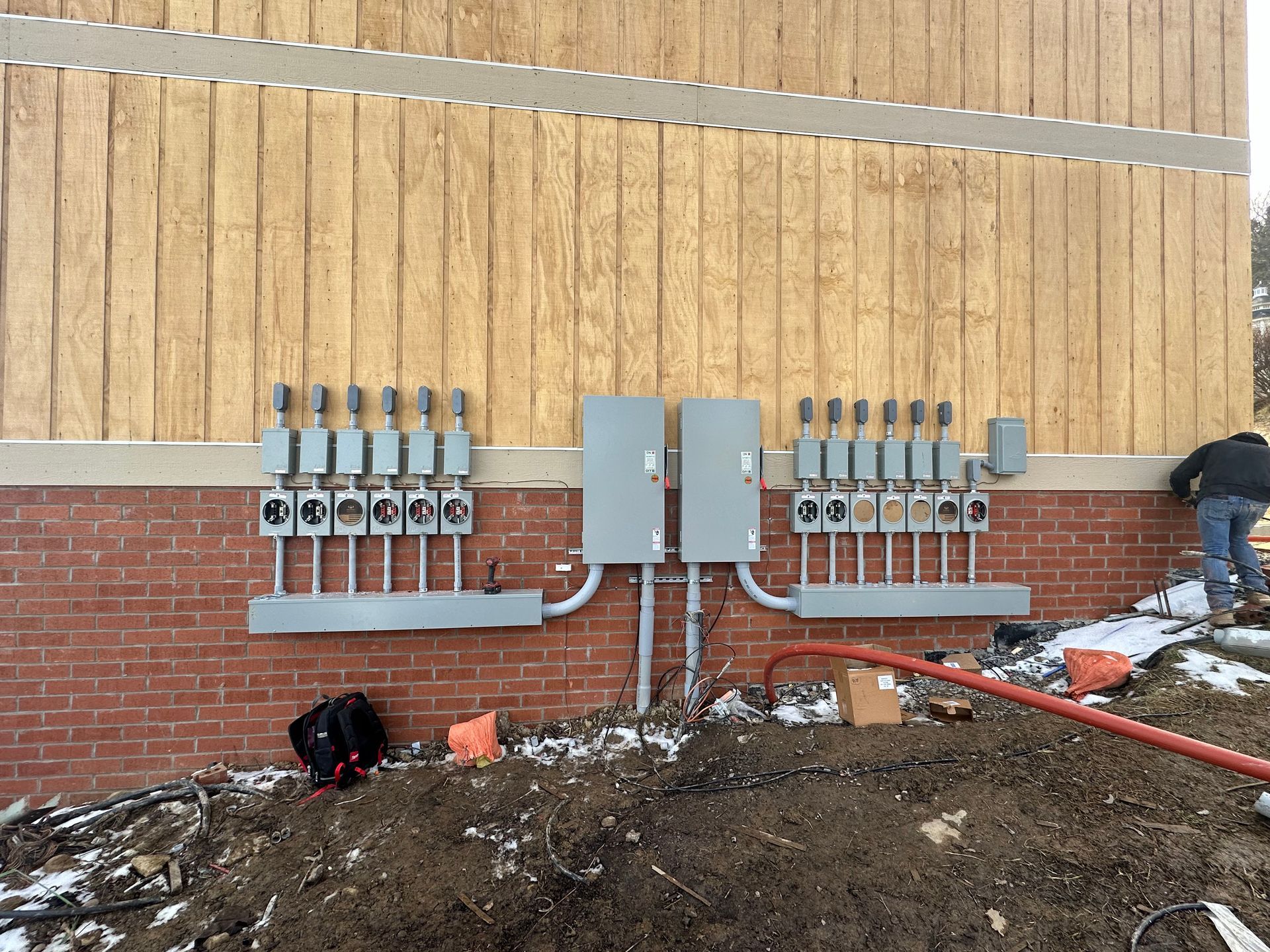 A brick building with electrical boxes on the side of it.