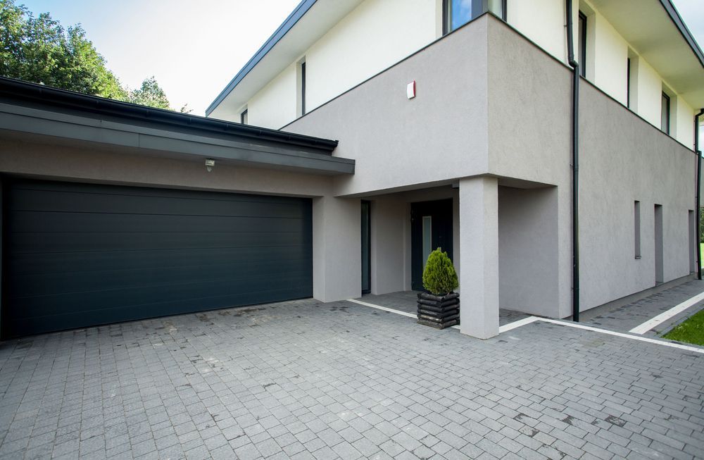 A large house with a garage and a driveway in front of it.