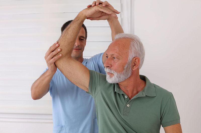 Man is being helped for arthritis. Stem Cells Philadelphia offers less invasive treatments such as injections of platelet-rich plasma (PRP) and stem cell therapy to treat arthritis.