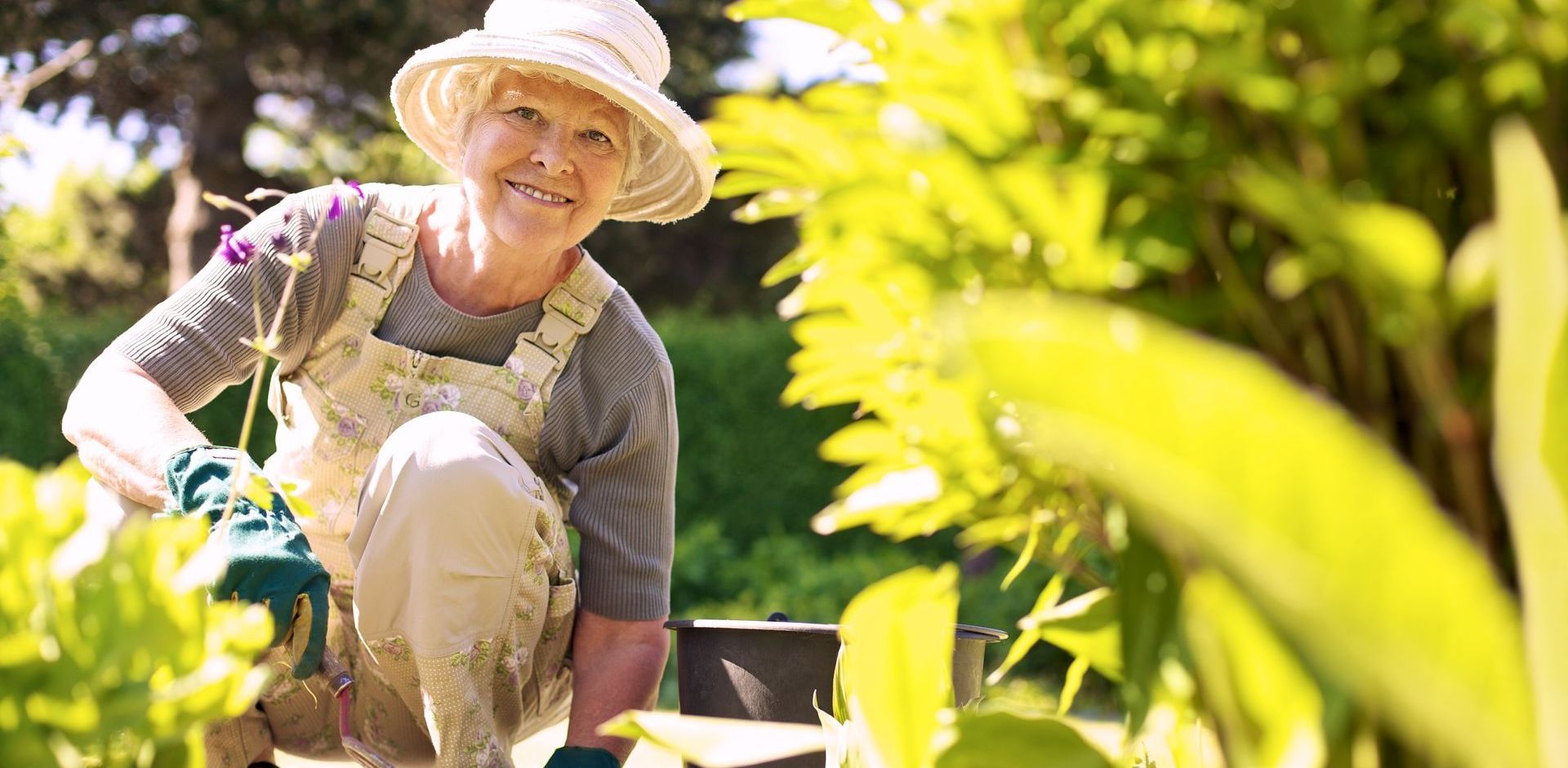 Elderly woman is kneeling down in a garden. Stem Cells Philadelphia offers less invasive treatments such as injections of platelet-rich plasma (PRP) and stem cell therapy to treat arthritis.