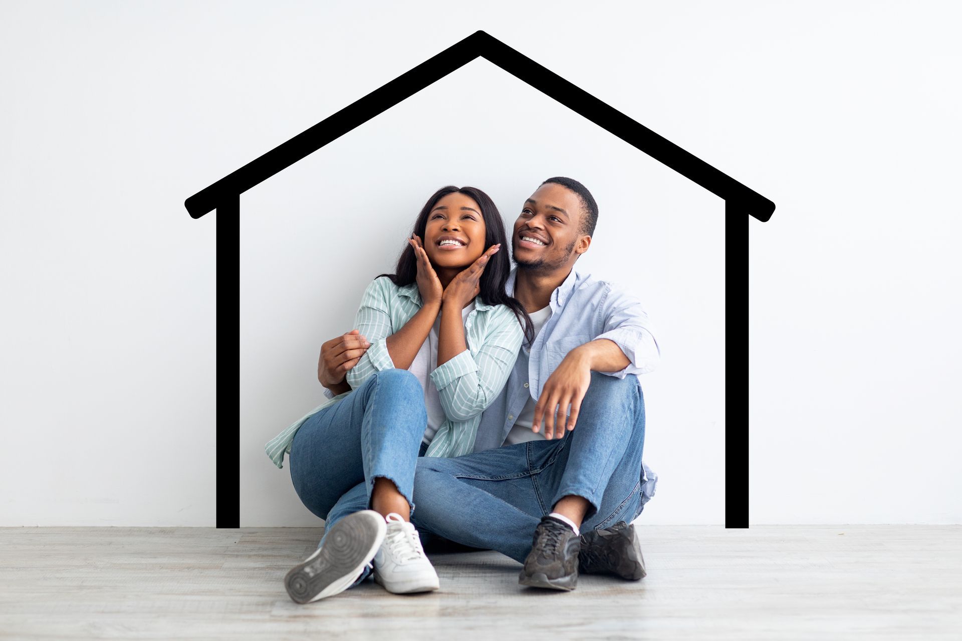 Couple sitting, smiling, looking upward under drawn house outline.