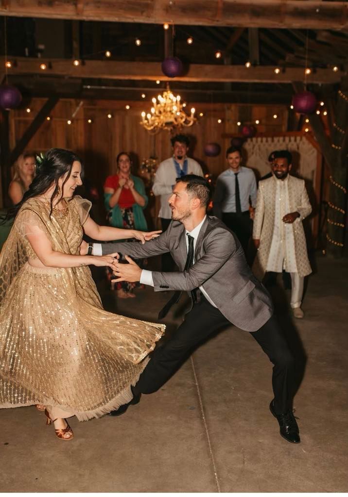 A bride and groom are dancing together at their wedding reception.