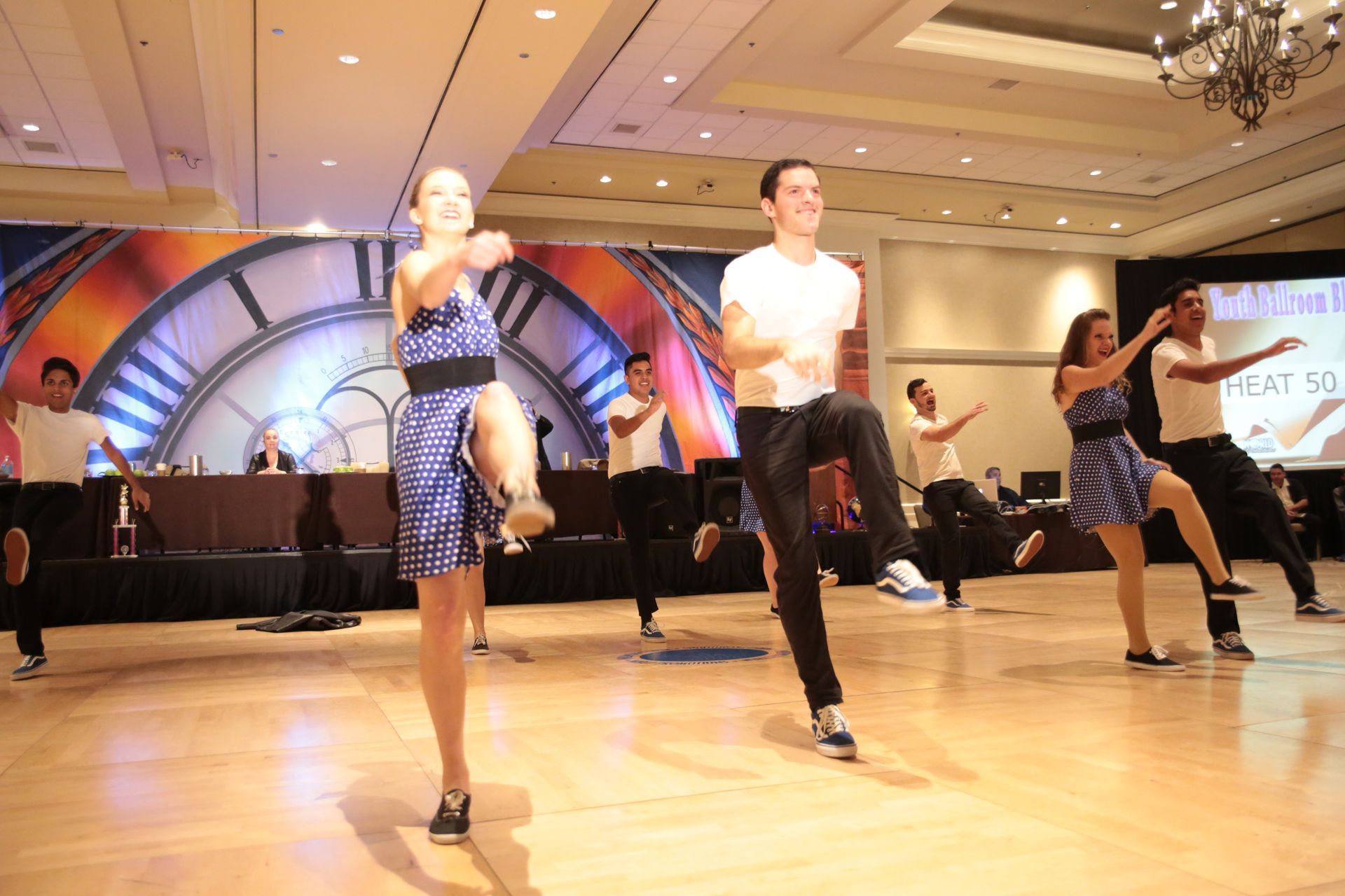 A group of people are dancing on a dance floor