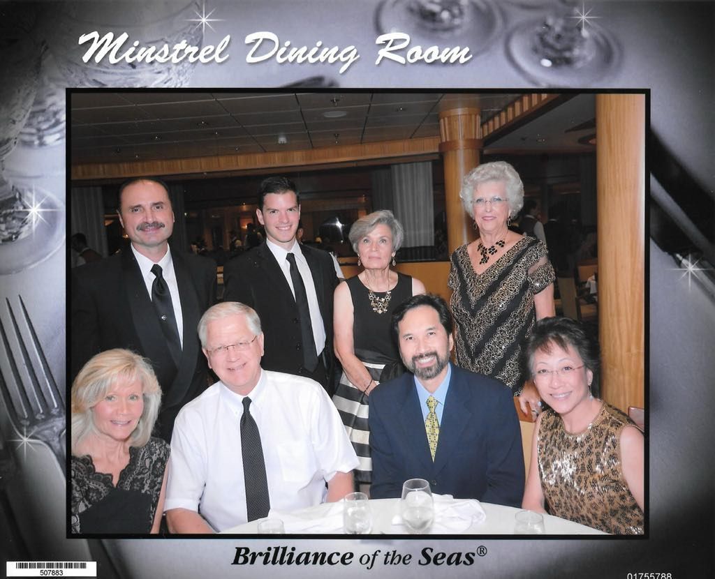 A group of people are posing for a photo in the minstrel dining room