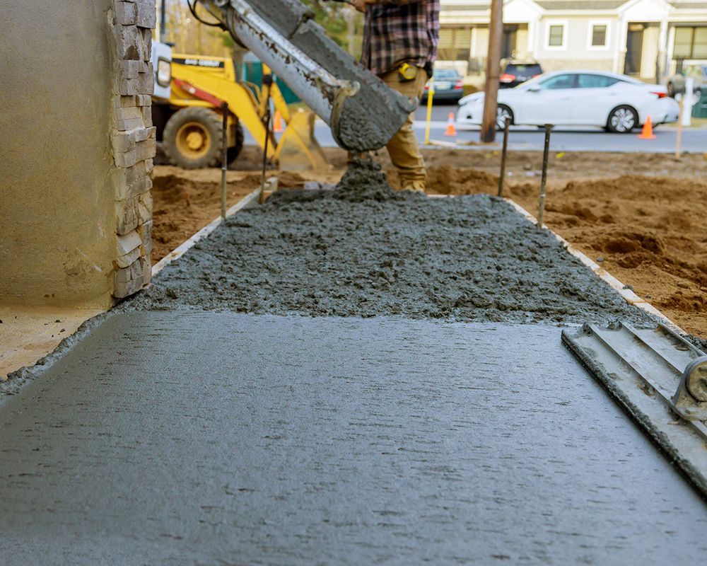 Worker Pouring Concrete on a Sidewalk – Oahu, HI – Oahu Sealcoating & Paving