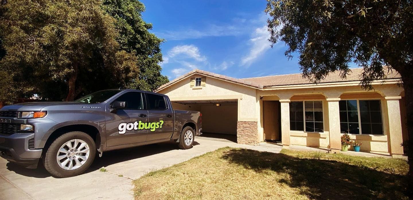 A truck is parked in front of a house.