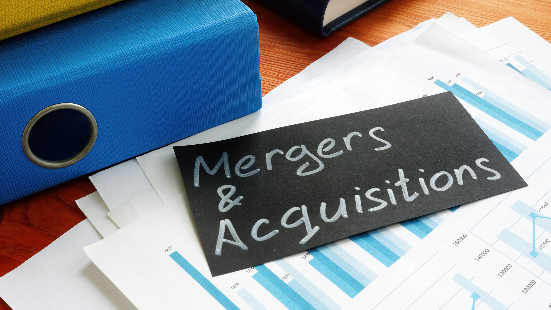 A chalkboard with the words mergers and acquisitions written on it