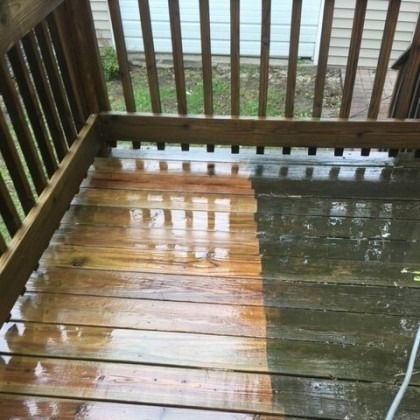 Half of a wooden deck is cleaned, showing the contrast between dirty and freshly cleaned boards.