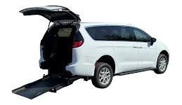 White van with open doors and a wheelchair lift.