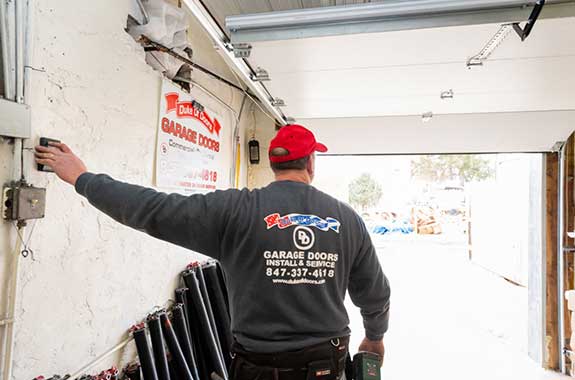 Worker Checking the Garage Door — Antioch, IL — Duke of Doors
